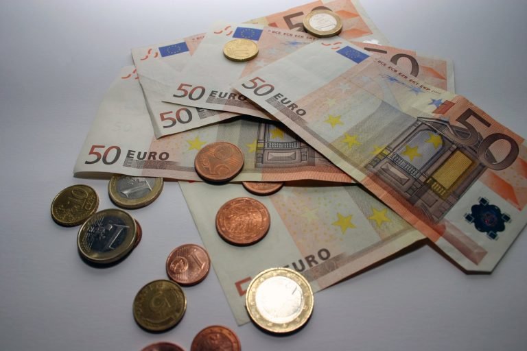 Euro banknotes and coins on a table