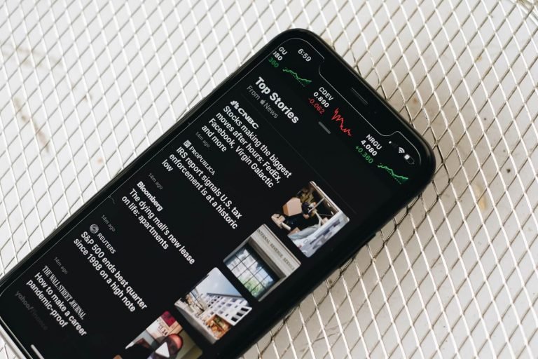Smartphone showing an app on a white surface