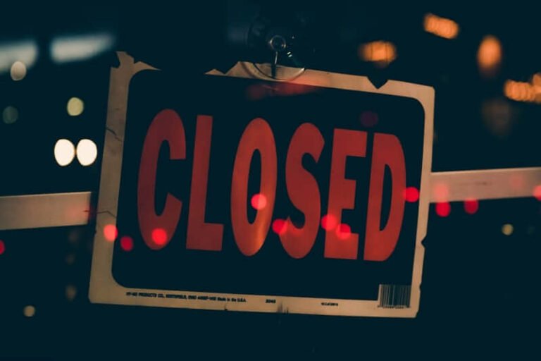 Red "Closed" sign in a shop window