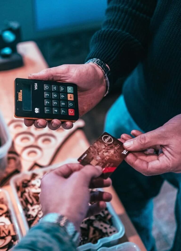 Person holding a phone and a payment card