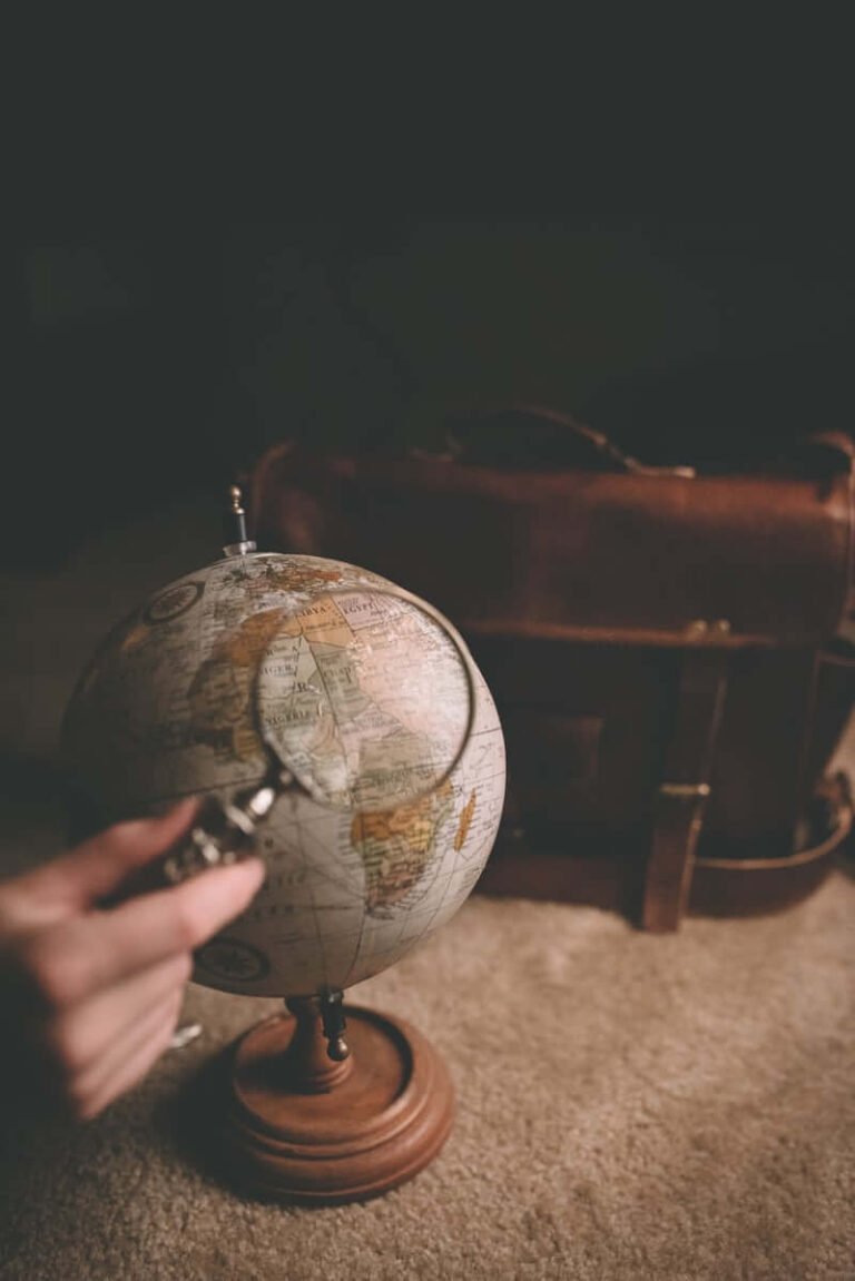 Hand touching an antique globe