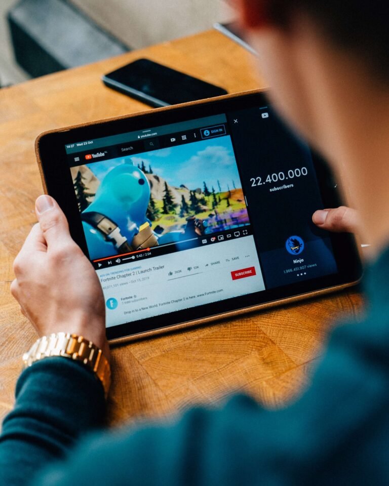 Person holding a tablet that is playing a video