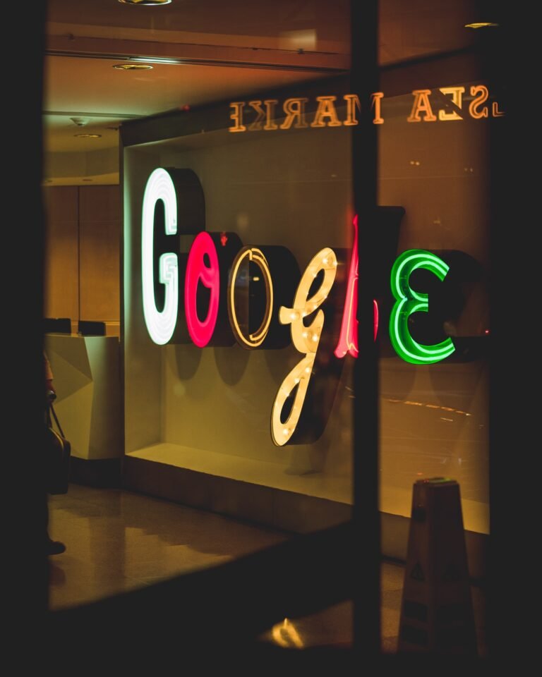 Illuminated Google logo on an office wall