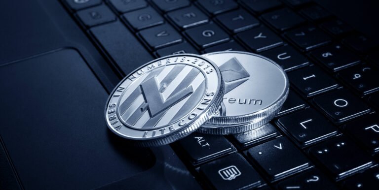 Silver coins lying on a laptop keyboard