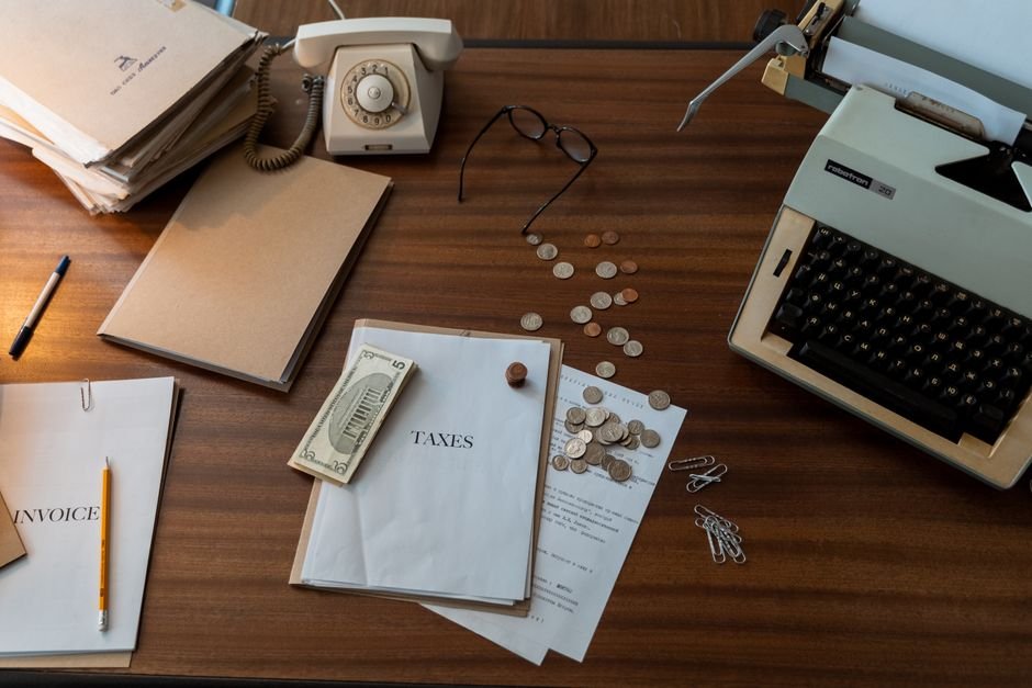 Desk with official letters, laptop, and coffee mug in home office