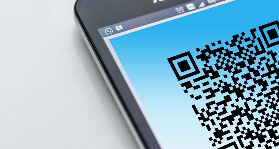Person scanning paper receipt with smartphone for expense tracking