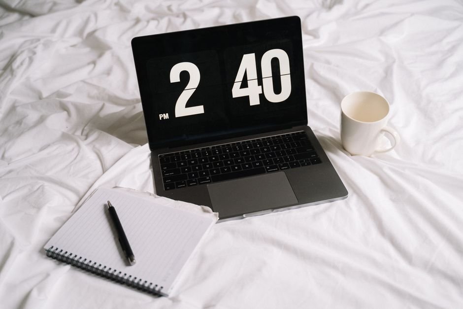 Laptop displaying organised task checklist with coffee cup on desk