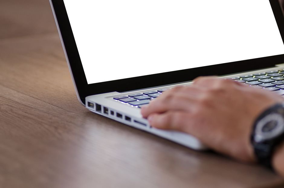 Content creator drafting article on computer using AI writing tools