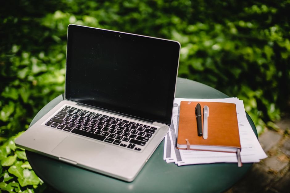 Freelancer using AI tools on laptop at home office desk