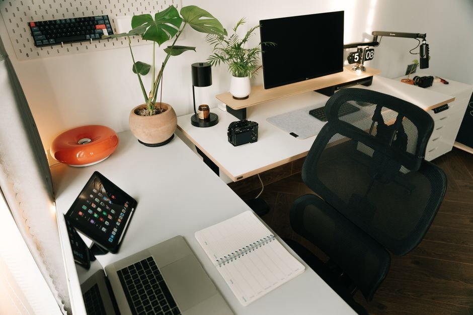 Clean desk setup with notebook and computer showing organized digital workspace