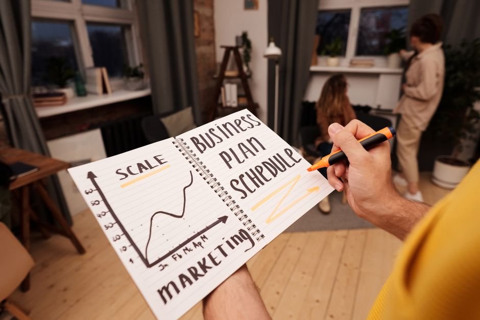 Person writing in a notebook while planning product strategy and decisions