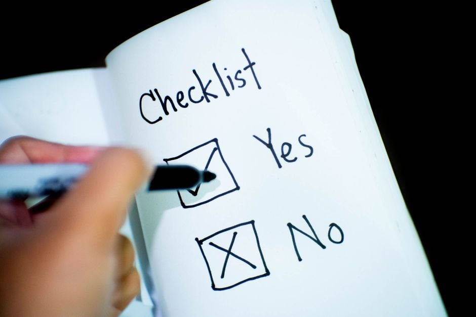 Entrepreneur reviewing evaluation checklist for business software decision