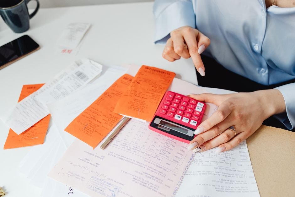 Business receipts and calculator on workspace for expense tracking
