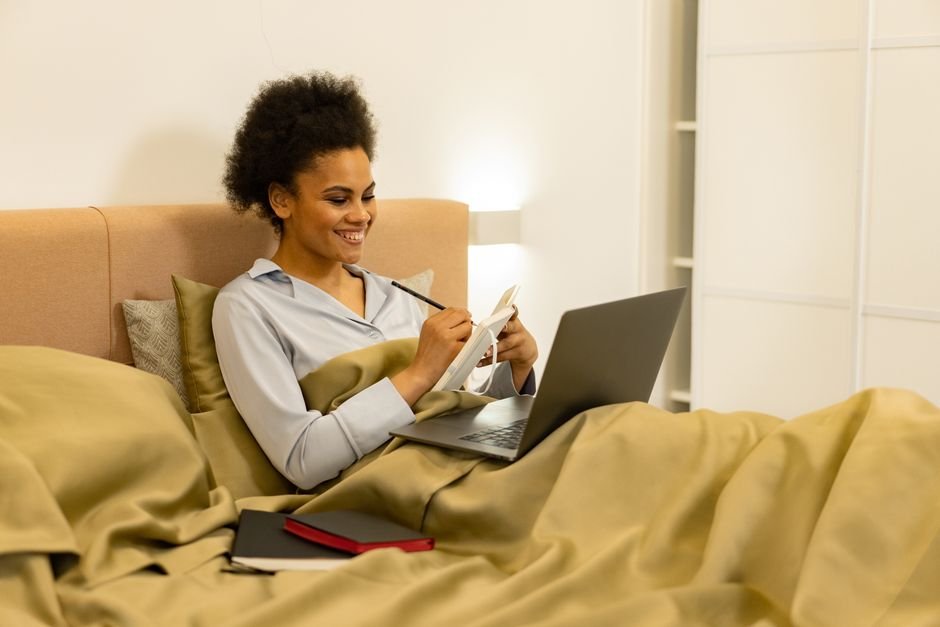 Business owner reviewing daily habits on laptop in morning workspace