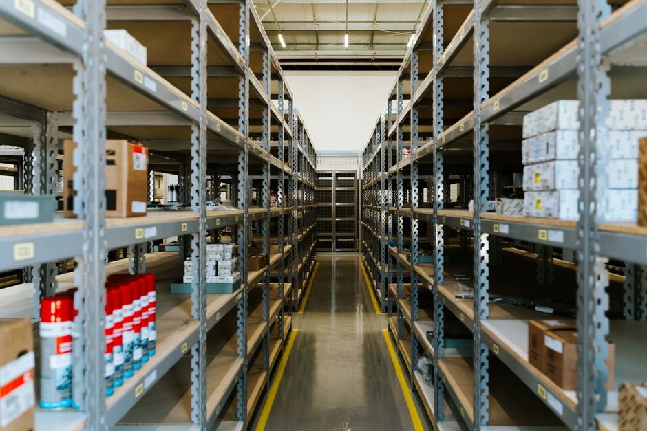 Organized warehouse shelves with product inventory boxes