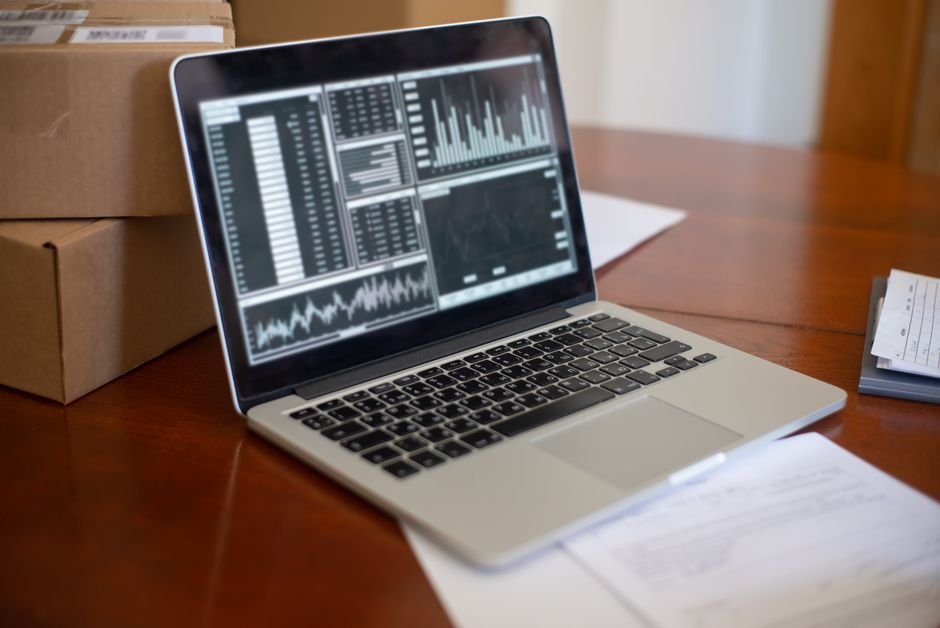 Person updating inventory stock levels on laptop