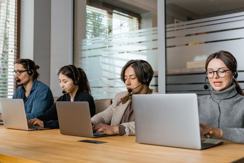 Customer support team collaborating on help documentation at desk