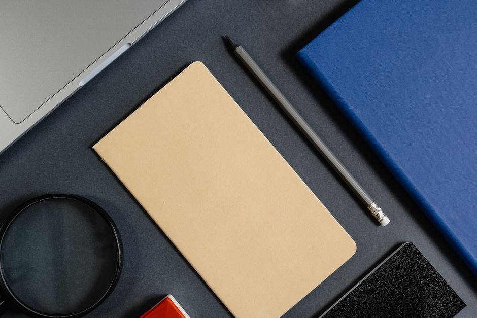 Stopwatch and notebook on desk for logging billable hours