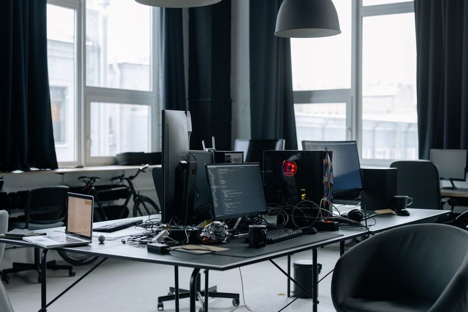Modern startup workspace with team members collaborating at desks