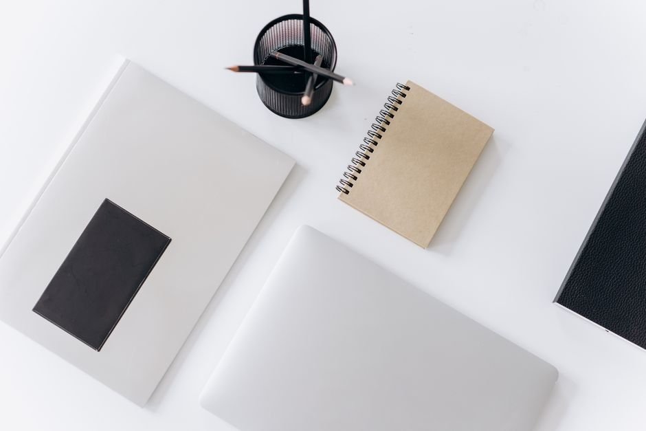 Clean organized workspace with laptop showing structured documentation