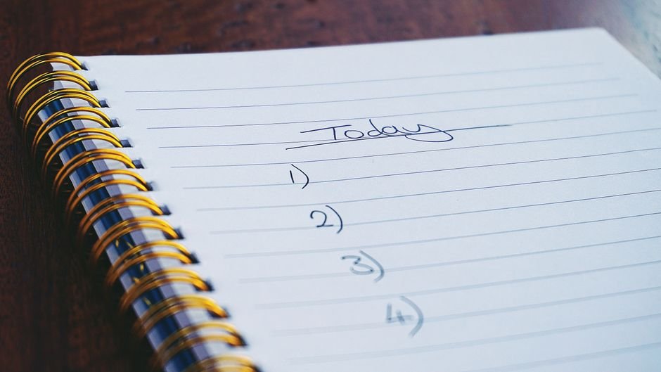 Notebook with checklist showing systematic prompt testing workflow steps