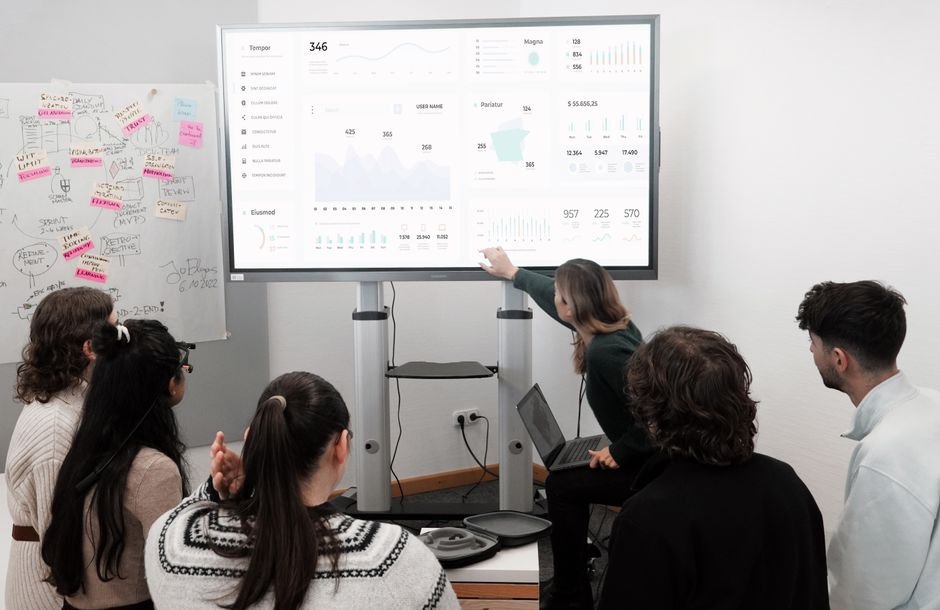 Team reviewing AI tool performance metrics on a shared dashboard